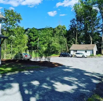 a driveway with cars parked in front of a house at Historic Barn - 2 Bedroom Apartment Close To Legoland NY in Goshen