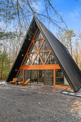 a house with a triangular roof with glass at Hot Tub Sauna Spacious Backyard Luxury in Jim Thorpe