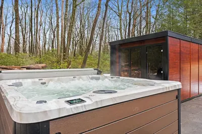 a jacuzzi tub sitting on a patio at Hot Tub Sauna Spacious Backyard Luxury in Jim Thorpe