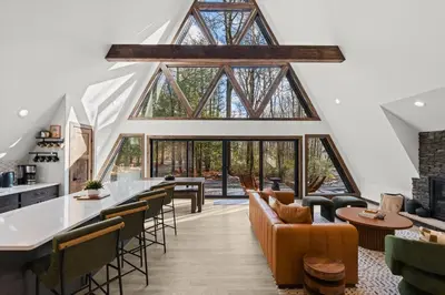 an open living room with large windows and a bar at Hot Tub Sauna Spacious Backyard Luxury in Jim Thorpe