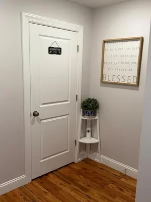 a white door with a sign on it in a room at Exclusive Home in Newark
