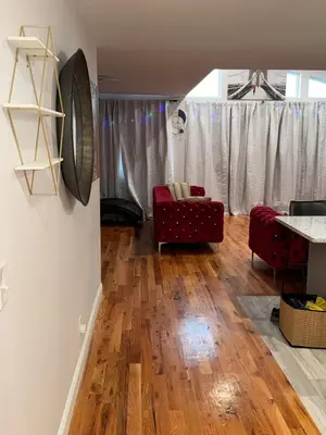 a living room with a red couch and a table at Exclusive Home in Newark
