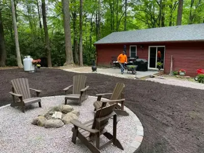 a group of chairs and a fire pit in front of a cabin at Sullivan Trail Cottage in Tannersville