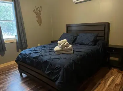 a bedroom with a bed with towels on it at Sullivan Trail Cottage in Tannersville