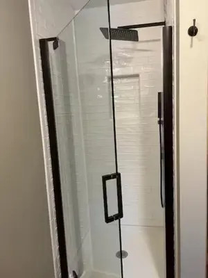 a shower with a glass door in a bathroom at Sullivan Trail Cottage in Tannersville