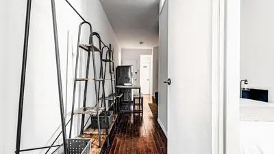 a hallway with wooden floors and shelves in a room at Monthly Furnished 2BD in Hudson Yard, Manhattan, NYC! in New York