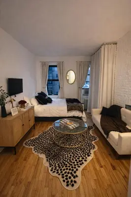 a living room with a couch and a table at Chic West Village Studio on Bleecker Street in New York