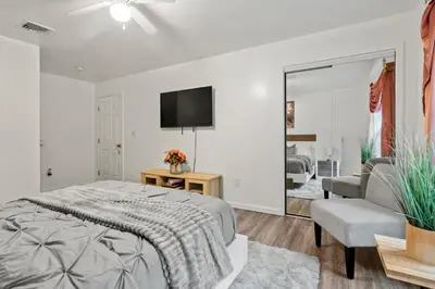 a bedroom with a bed and a tv and a couch at Ethereal Haven in West Milford