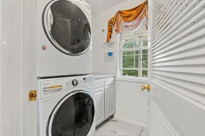 a white laundry room with a washer and dryer at Ethereal Haven in West Milford