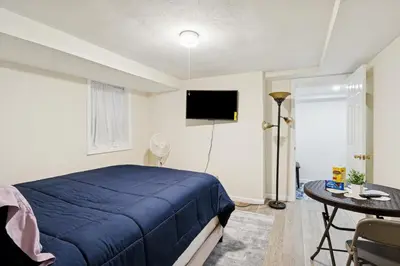 a bedroom with a bed and a table and a tv at Heaven in Newark