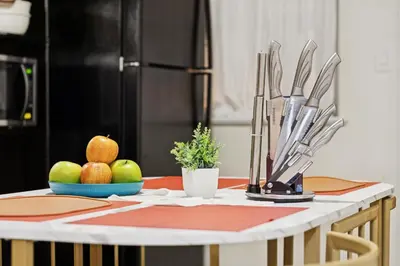 a kitchen table with apples and utensils on it at Heaven in Newark
