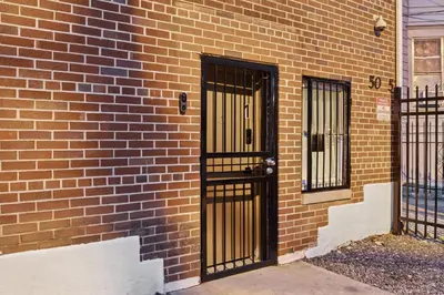 a brick building with black gates on the side of it at Heaven in Newark