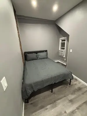 a small bedroom with a bed in the corner at The loft 2 bedroom apartment in Newark