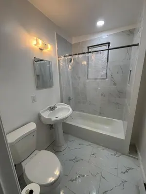a bathroom with a toilet and a sink and a shower at The loft 2 bedroom apartment in Newark