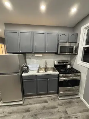 a kitchen with a sink and a stove top oven at The loft 2 bedroom apartment in Newark