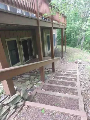 a house with a bench in front of it at Cozy 4bd 4bath Grand Cabin Retreat in Camelback in Tannersville