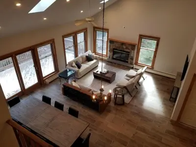 an aerial view of a living room with couches and a fireplace at Cozy 4bd 4bath Grand Cabin Retreat in Camelback in Tannersville