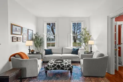 a living room with a couch and chairs and a table at Riverfront Gem with Balcony, Patio and City Views in Harrisburg