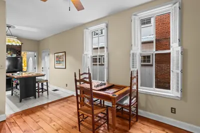 a dining room with a table and chairs and windows at Riverfront Gem with Balcony, Patio and City Views in Harrisburg
