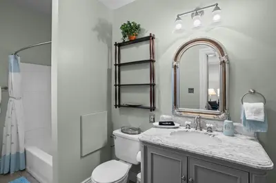 a bathroom with a sink and a toilet and a mirror at Riverfront Gem with Balcony, Patio and City Views in Harrisburg