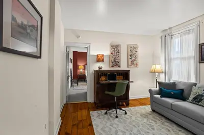 a living room with a couch and a desk at Riverfront Gem with Balcony, Patio and City Views in Harrisburg