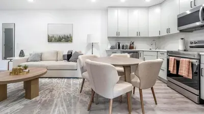 a kitchen and living room with a table and chairs at Landing Modern 2BD Gym in Philadelphia
