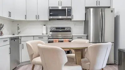 a kitchen with a table with chairs and a microwave at Landing Modern 2BD Gym in Philadelphia