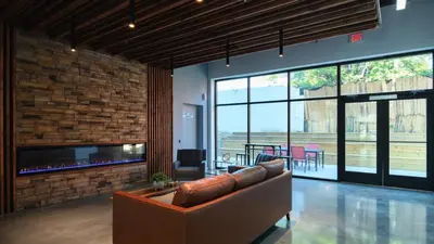 a living room with a couch and a fireplace at Landing Modern 2BD Gym in Philadelphia