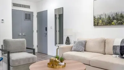 a living room with a couch and a table at Landing Modern 2BD Gym in Philadelphia
