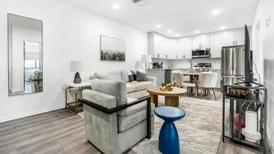 a living room with a couch and a kitchen at Landing Modern 2BD Gym in Philadelphia