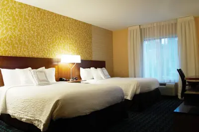 a hotel room with two beds and a window at Fairfield Inn & Suites by Marriott Stroudsburg Bartonsville/Poconos in Stroudsburg
