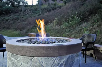 a fire pit in a patio with two chairs at Fairfield Inn & Suites by Marriott Stroudsburg Bartonsville/Poconos in Stroudsburg