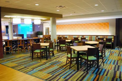 a dining area with tables and chairs in a library at Fairfield Inn & Suites by Marriott Stroudsburg Bartonsville/Poconos in Stroudsburg