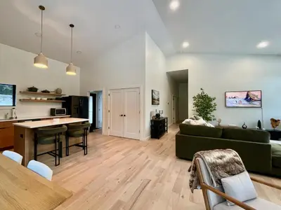 a living room with a green couch and a table at White Pine Chalet in Yulan