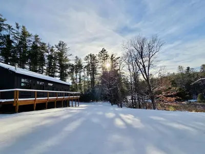 a snow covered road next to a wooden bridge at White Pine Chalet in Yulan