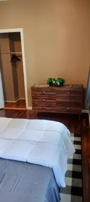 a bedroom with a white bed and a dresser at Fill Your Headspace with Tranquility Near NYC in Maplewood