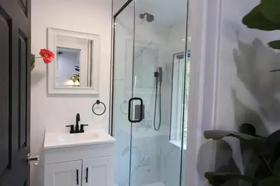 a bathroom with a sink and a glass shower at Creekside Family Dreamland - Hot Tub, Firepit, Arcade in Pocono Summit