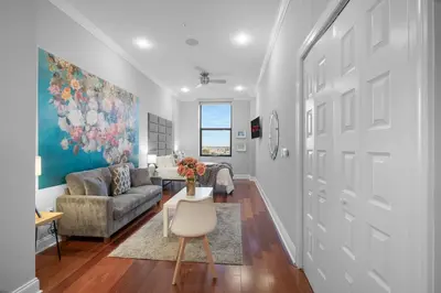 a living room with a couch and a table at Chic High Rise Apt Lux Loft with Pool,Deck & Gym in Philadelphia