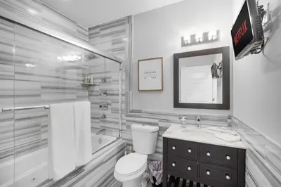 a bathroom with a toilet and a sink and a tub at Chic High Rise Apt Lux Loft with Pool,Deck & Gym in Philadelphia
