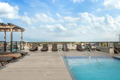 a swimming pool on the roof of a building at Chic High Rise Apt Lux Loft with Pool,Deck & Gym in Philadelphia