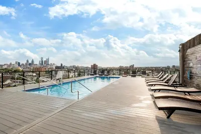 a swimming pool on the roof of a building at Chic High Rise Apt Lux Loft with Pool,Deck & Gym in Philadelphia