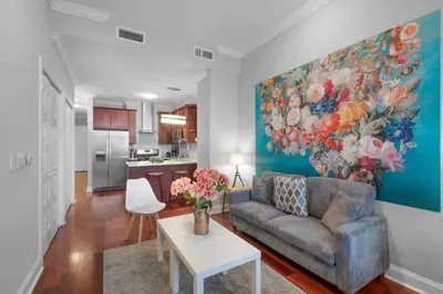 a living room with a couch and a painting on the wall at Chic High Rise Apt Lux Loft with Pool,Deck & Gym in Philadelphia