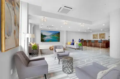 a living room with couches and chairs in a room at Chic High Rise Apt Lux Loft with Pool,Deck & Gym in Philadelphia