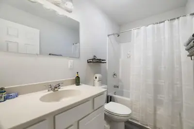 a bathroom with a sink and a toilet and a shower at Spacious Vacation Home Tobyhanna Gym BBQ Boat in Pocono Country Place