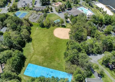 an aerial view of a yard with two swimming pools at Spacious Vacation Home Tobyhanna Gym BBQ Boat in Pocono Country Place