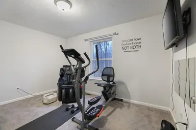 a room with a gym with a treadmill at Spacious Vacation Home Tobyhanna Gym BBQ Boat in Pocono Country Place