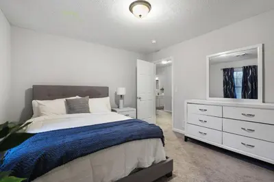 a bedroom with a bed and a dresser and a mirror at Spacious Vacation Home Tobyhanna Gym BBQ Boat in Pocono Country Place