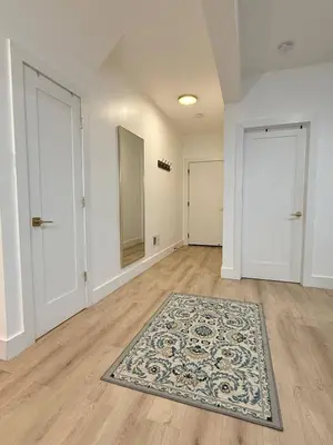 an empty room with two doors and a rug at Modern 3BR Home | Chic & Cozy | 30 Min NYC Access in Jersey City