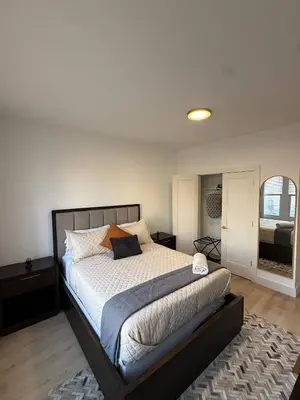 a bedroom with a large bed in a room at Modern 3BR Home | Chic & Cozy | 30 Min NYC Access in Jersey City