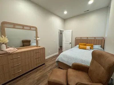 a bedroom with a large bed and a mirror at 3961 Baltimore Penn Campus in Philadelphia